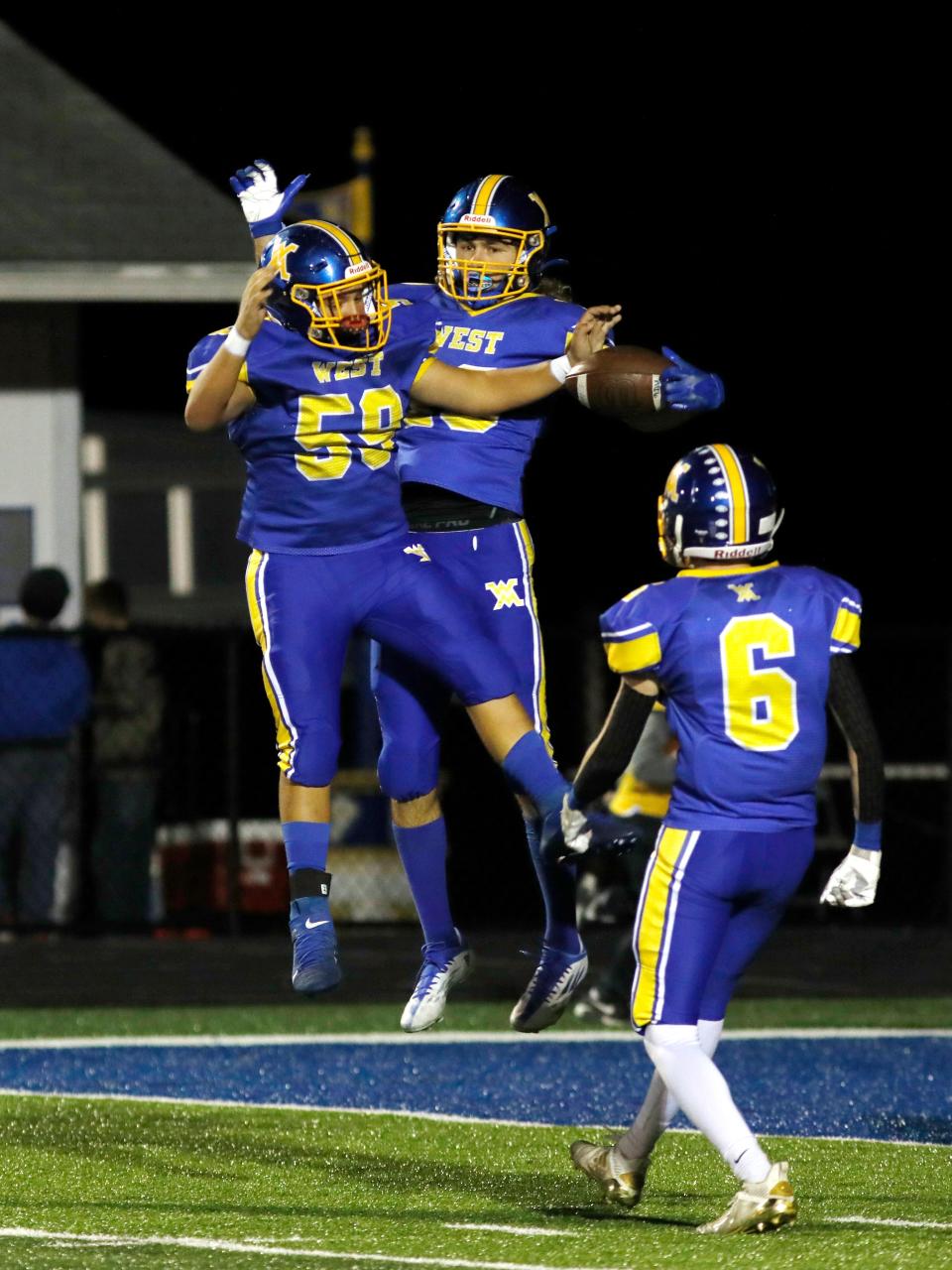 Slater Sampsel celebrates with sophomore Kaiden Fleming, left, after catching a 34-yard touchdown pass in the second quarter of West Muskingum's 26-20 win against visiting Morgan on Friday night in Falls Township. Slater caught three touchdowns.