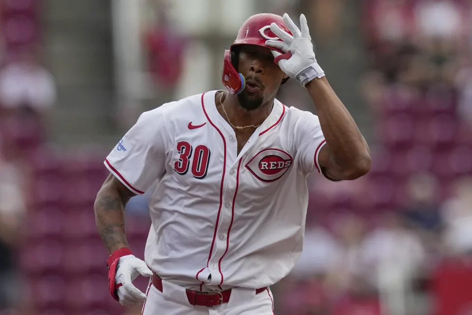 Cincinnati Reds' Will Benson tips his hat as he rounds the bases after hitting a home run during the third inning of a baseball game against the Oakland Athletics, Thursday, Aug. 29, 2024, in Cincinnati. (AP Photo/Carolyn Kaster)