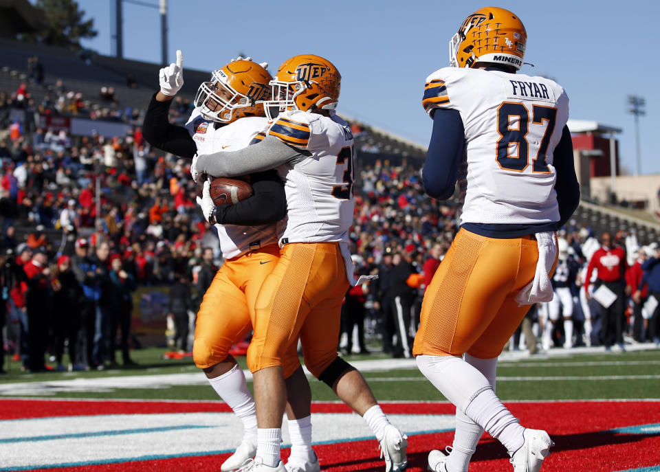 UTEP tight end Trent Thompson, left, celebrates with teammates after scoring a touchdown against Fresno State during the first half of the New Mexico Bowl NCAA college football game Saturday, Dec. 18, 2021, in Albuquerque, N.M. (AP Photo/Andres Leighton)