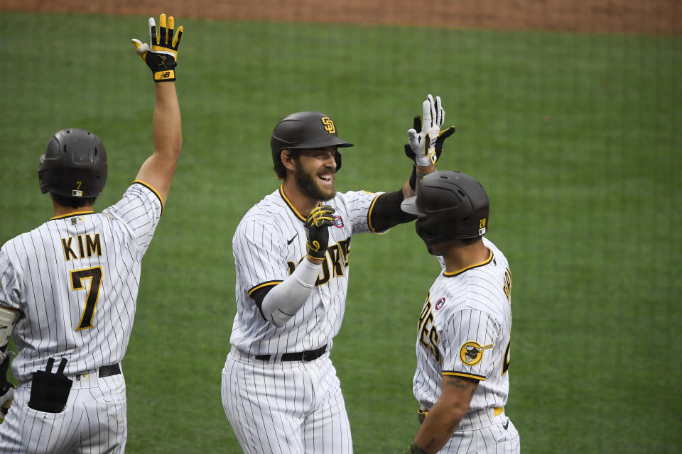 San Diego Padres' Austin Nola (26) is congratulated by Ha-Seong Kim (7) and Tommy Pham (28) after hitting a three-run home run during the third inning of a baseball game against the St. Louis Cardinals, Saturday, May 15, 2021, in San Diego. (AP Photo/Denis Poroy)