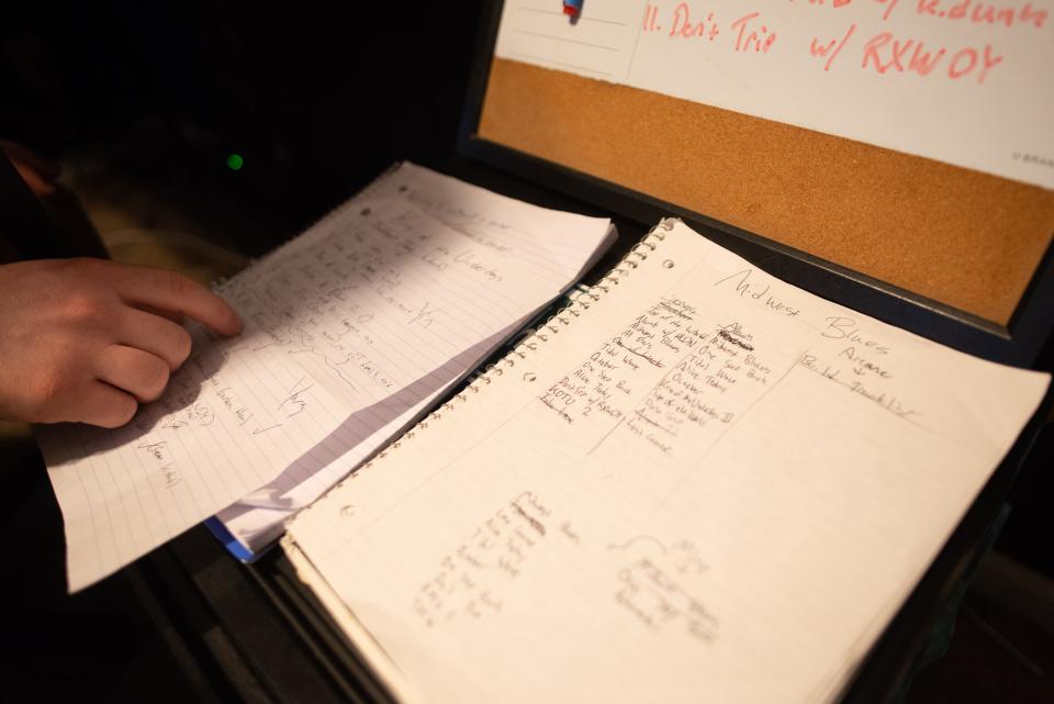 Ethan Dolsky points to songs on a piece of paper as he explains how putting together his newest album, "Midwest Blues," under the stage name, Fat Dolsk, from his home studio Saturday morning.