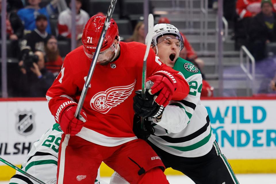 Detroit Red Wings center Dylan Larkin (71) and Dallas Stars center Roope Hintz (24) fight for position in front of Dallas Stars goaltender Jake Oettinger (29) in the second period at Little Caesars Arena in Detroit on Tuesday, Jan. 23, 2024.