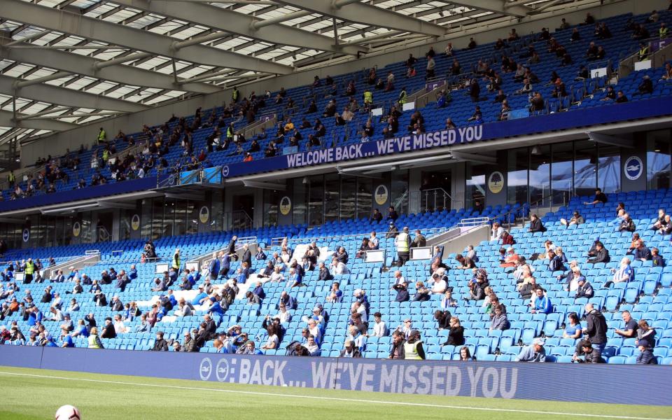 Brighton and Hove Albion fans take their seats in the stands with social distancing measures before the pre-season friendly at the AMEX Stadium in Brighton where up to 2500 fans have been allowed in to watch the match after the Government announced a further batch of sporting events that will be used to pilot the safe return of spectators - PA /Adam Davy 