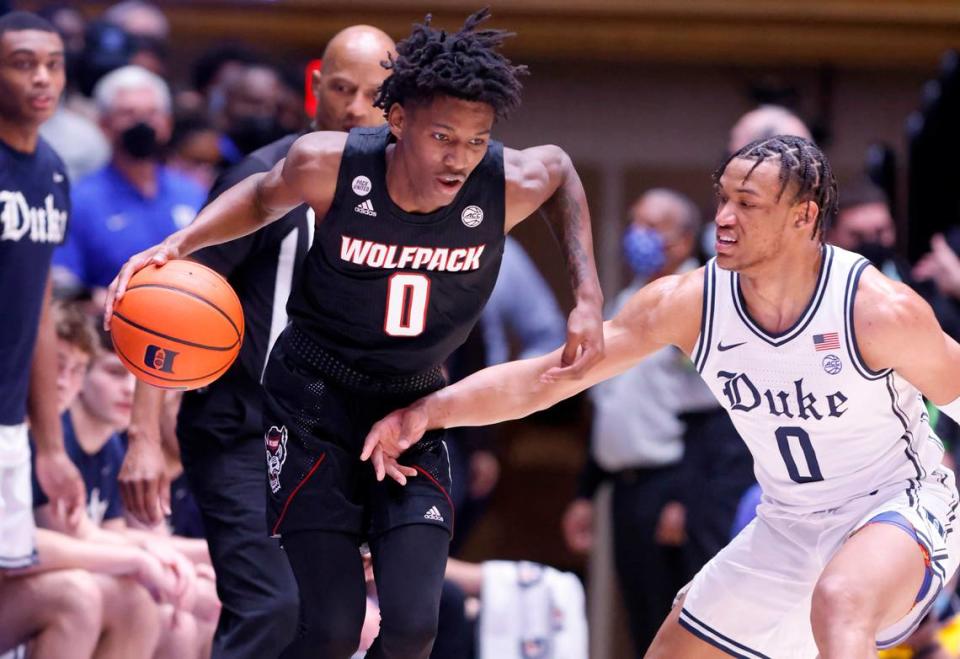 N.C. State’s Terquavion Smith (0) drives around Duke’s Wendell Moore Jr. (0) during the first half of Duke’s game against N.C. State at Cameron Indoor Stadium in Durham, N.C., Saturday, January 15, 2022.