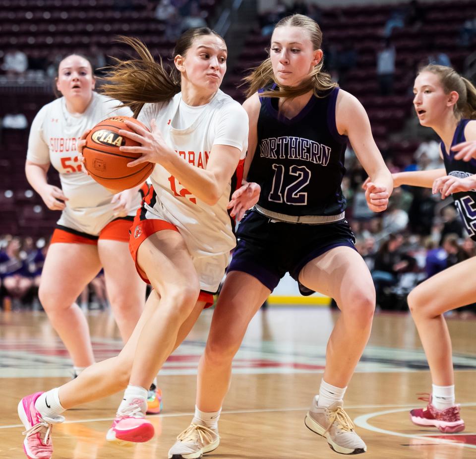 York Suburban's Lydia Powers drives to the basket during the District 3 Class 5A girls' basketball championship against Northern York at the Giant Center on March 1, 2024, in Hershey. The Trojans won in overtime, 37-35.