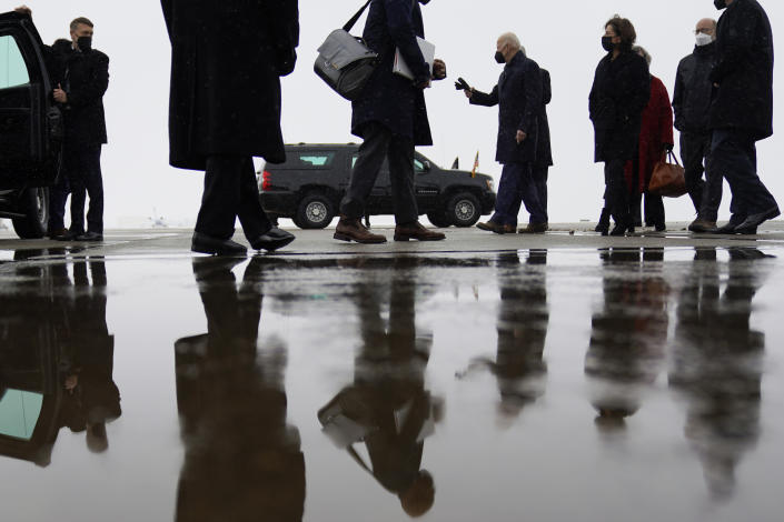 President Joe Biden walks to the motorcade with Commerce Secretary Gina Raimondo, third from right, and Pennsylvania Gov. Tom Wolf, second from right, at Allegheny County Airport in West Mifflin, Penn., Friday, Jan. 28, 2022. (AP Photo/Andrew Harnik)