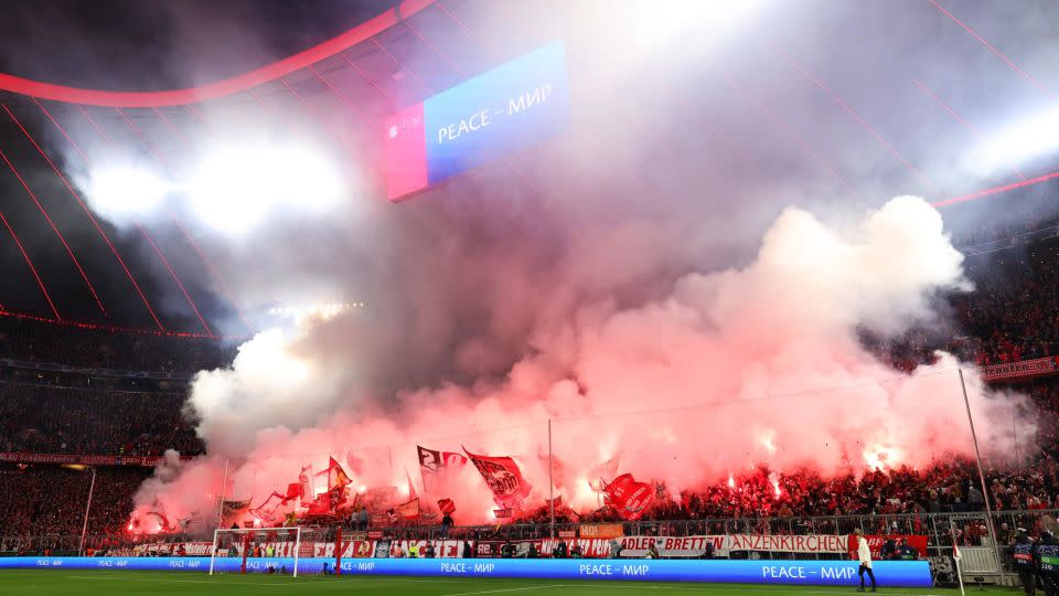 Bayern Munich fans show their support with flares prior to the quarterfinal match against Arsenal FC at the Allianz Arena. - Alexander Hassenstein/Getty Images Europe/Getty Images