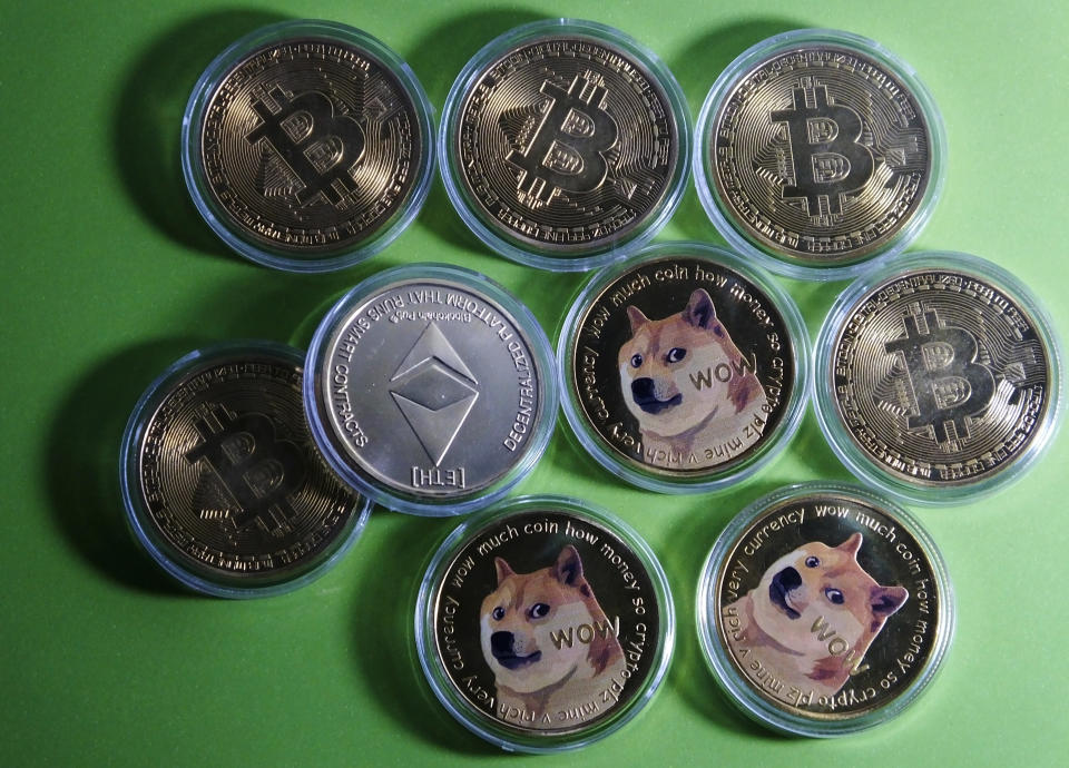 Bitcoin, Dogecoin and Ethereum physical commemorative coins are displayed in Yichang, Hubei Province, China. Photo: Costfoto/Barcroft Media via Getty Images