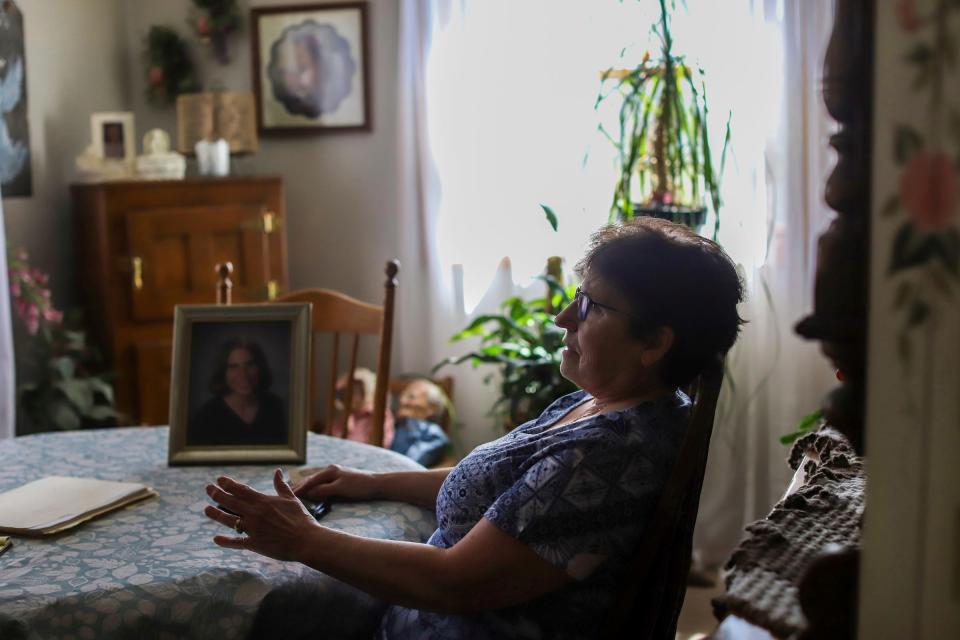 Vicky Cupp, 67, of Tecumseh, sits at her dining room table going over all the documents she has collected over the years related to the murder of her daughter Kyle Smith, who was shot outside of a nightclub on Woodward Avenue the night before Super Bowl XL in Detroit. Cupp says the police told her family that it was a “delayed arrest” situation, but 18 years later the family still does not know what happened to Kyle, who was 24 at the time of her death.