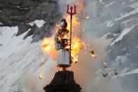 The Boeoegg, a snowman, is burning in a bonfire on Devil's Bridge near Andermatt