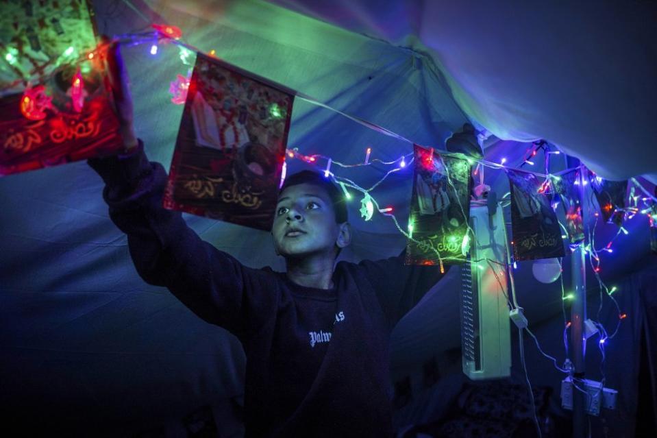 Abdul Rahman Al-Helou, 11, decorates his tent for Ramadan on March 10, 2024.