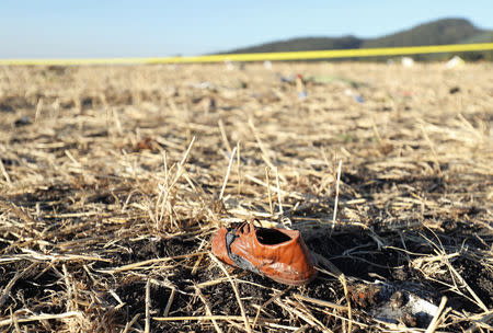 FILE PHOTO: A shoe of a passenger is seen at the scene of the Ethiopian Airlines Flight ET 302 plane crash, near the town of Bishoftu, southeast of Addis Ababa, Ethiopia March 10, 2019. REUTERS/Tiksa Negeri