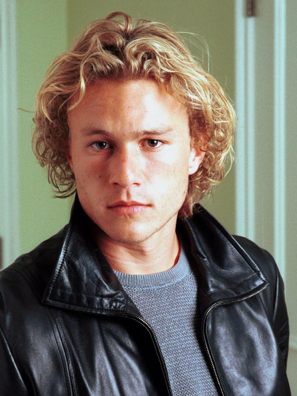 Heath wearing a leather jacket and a sweater