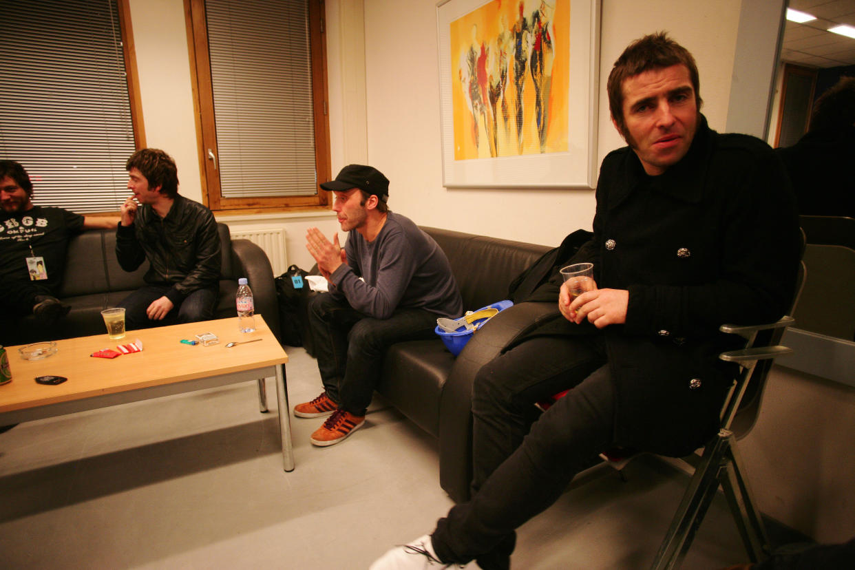 Noel Gallagher, Andy Bell, and Liam Gallagher with VIP guests backstage at an Oasis concert at the Heineken Music Hall on January 21st, 2009 in Amsterdam, Netherlands. (Photo by Mick Hutson/Redferns)