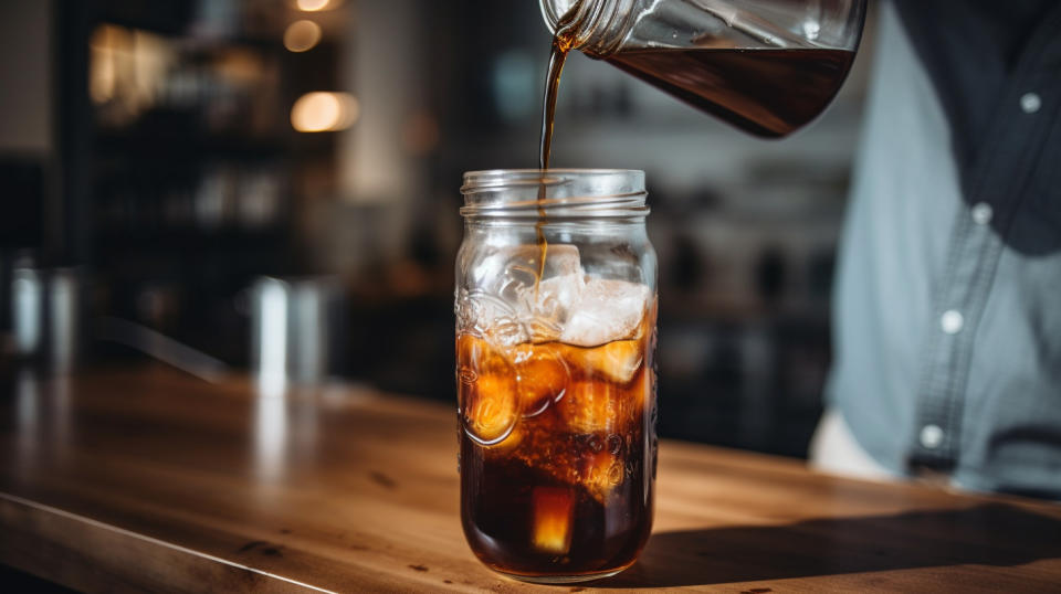 A closeup of a customer tasting a freshly-made cold brew coffee product from the company's shop.