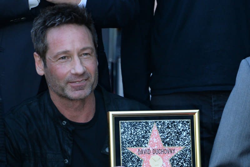 David Duchovny holds a replica plaque during an unveiling ceremony honoring him with the 2,572nd star on the Hollywood Walk of Fame in Los Angeles in 2016. File Photo by Jim Ruymen/UPI