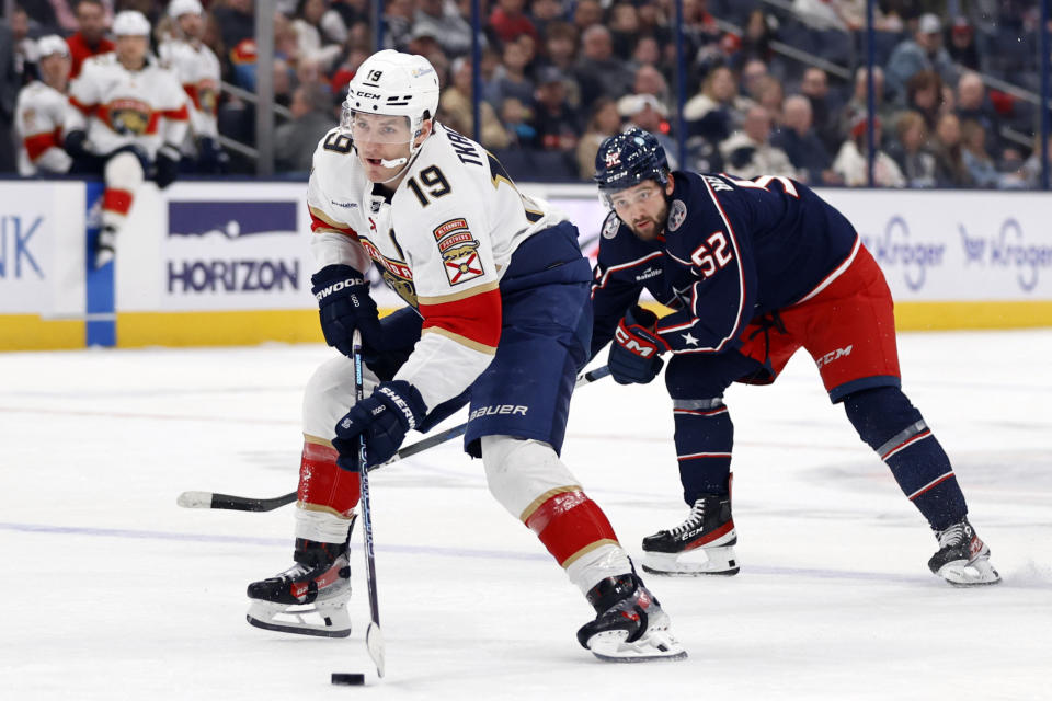 Florida Panthers forward Matthew Tkachuk, left, controls the puck in front of Columbus Blue Jackets forward Emil Bemstrom during the first period of an NHL hockey game in Columbus, Ohio, Sunday, Dec. 10, 2023. (AP Photo/Paul Vernon)