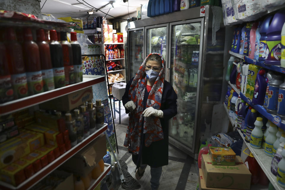Customer Azar Arayesh, wearing a protective face mask and gloves to help prevent the spread of the coronavirus, shops in a grocery in Tehran, Iran, Tuesday, April 21, 2020. Iran is the region's epicenter of the COVID-19 pandemic, though even Iran's parliament suggests the death toll is nearly double that and overall cases remain vastly underreported. (AP Photo/Vahid Salemi)