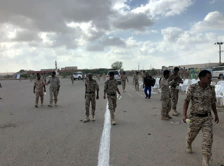 Soldiers inspect the scene of a Houthi drone attack at Yemeni government military parade in al-Anad air base, Lahaj province, Yemen January 10, 2019. REUTERS/Stringer