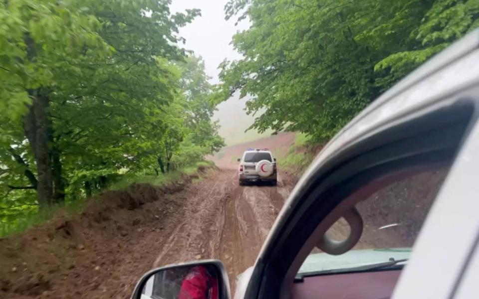 Iranian Red Crescent members rushing to the crash site.