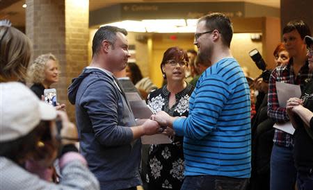 Isaac Troyo (L) and his partner Jed Mecham get married at the Salt Lake County Government Building in Salt Lake City, Utah, December 23, 2013. REUTERS/Jim Urquhart