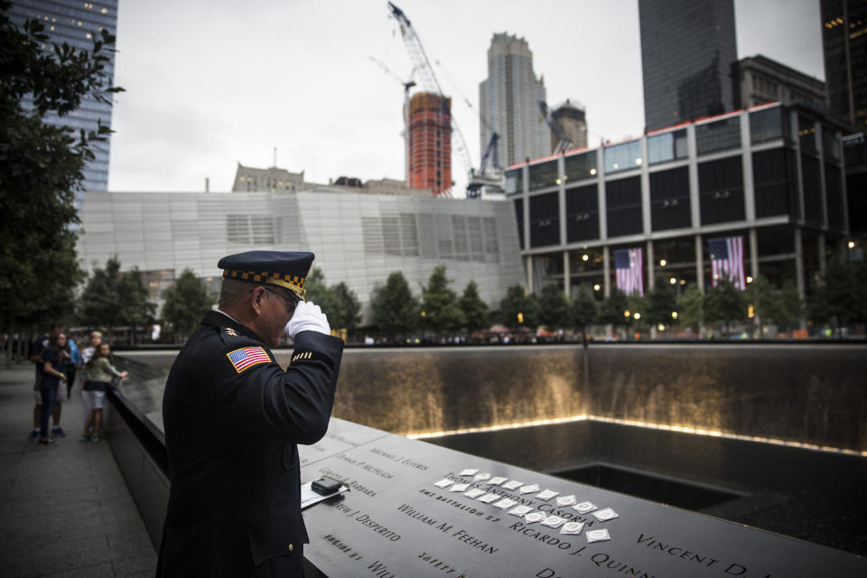 NEW YORK, NY - SEPTEMBER 11:   Sam Pulia, mayor of Westerchester, IL, and a former police officer of the same town, salutes the name of his cousin, New York firefighter Thomas Anthony Casoria, who was killed in the South Tower, prior to the the memorial observances held at the site of the World Trade Center in in New York on September 11, 2014. This year marks the 13th anniversary of the September 11th terrorist attacks that killed nearly 3,000 people at the World Trade Center, Pentagon and on Flight 93. (Photo by Andrew Burton - Pool /Getty Images)