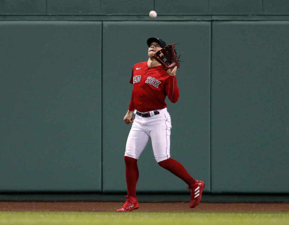 Boston - October 18: Red Sox CF Kike Hernandez makes the catch on a fly ball off he bat of the Astros Jose Altuve for the first out of the game. The Boston Red Sox host the Houston Astros for Game 3 of the ALCS at Fenway Park in Boston on Oct. 18, 2021. (Photo by Stan Grossfeld/The Boston Globe via Getty Images)