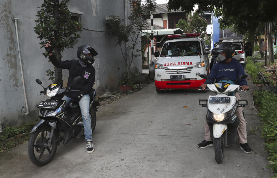 Motorcycle volunteers escort an ambulance carrying the body of a COVID-19 victim to a cemetery for burial in Bekasi on the outskirts of Jakarta, Indonesia, July 11, 2021. Indonesia surpassed the grim milestone of 100,000 official COVID-19 deaths on Wednesday, Aug. 4, 2021, as the country struggles with its worst pandemic year fueled by the delta variant, with growing concerns that the actual figure could be much higher with people also dying at home. (AP Photo/Achmad Ibrahim)