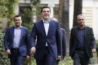 Greece's newly-appointed Prime Minister Alexis Tsipras (C) leaves the Presidential Mansion after his swearing-in ceremony as Greece's first leftist prime minister in Athens January 26, 2015. REUTERS/Marko Djurica