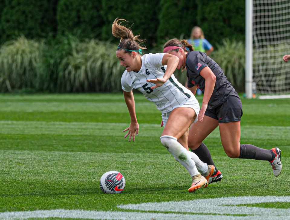 Michigan State's Regan Dalton (5) gets control over ball against Ohio State's Amanda Schlueter (2) Sunday, Sept. 17, 2023.