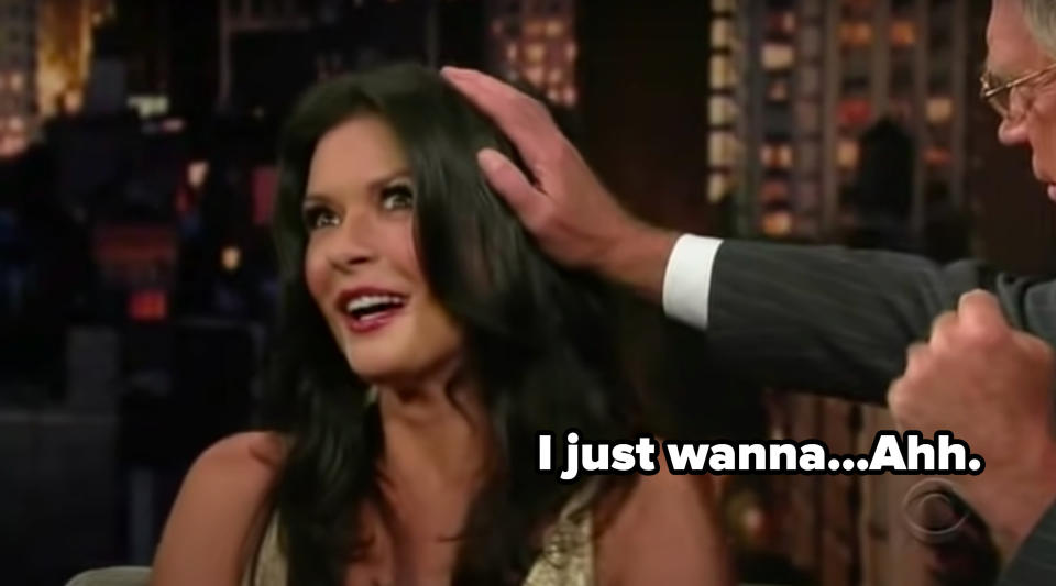 David Letterman touching Catherine Zeta-Jones's hair.