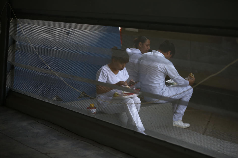 Medical workers take a lunch break outside the vaccination site, as the city health department conducts a mass coronavirus vaccination campaign for Mexicans over age 60, at Palacio de los Deportes, in Mexico City, Wednesday, Feb. 24, 2021. (AP Photo/Rebecca Blackwell)
