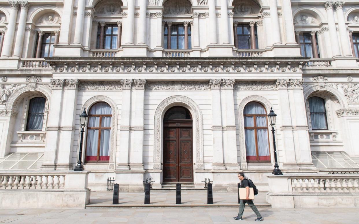 A man walks past the Foreign and Commonwealth Office on Whitehall, in Westminster, London