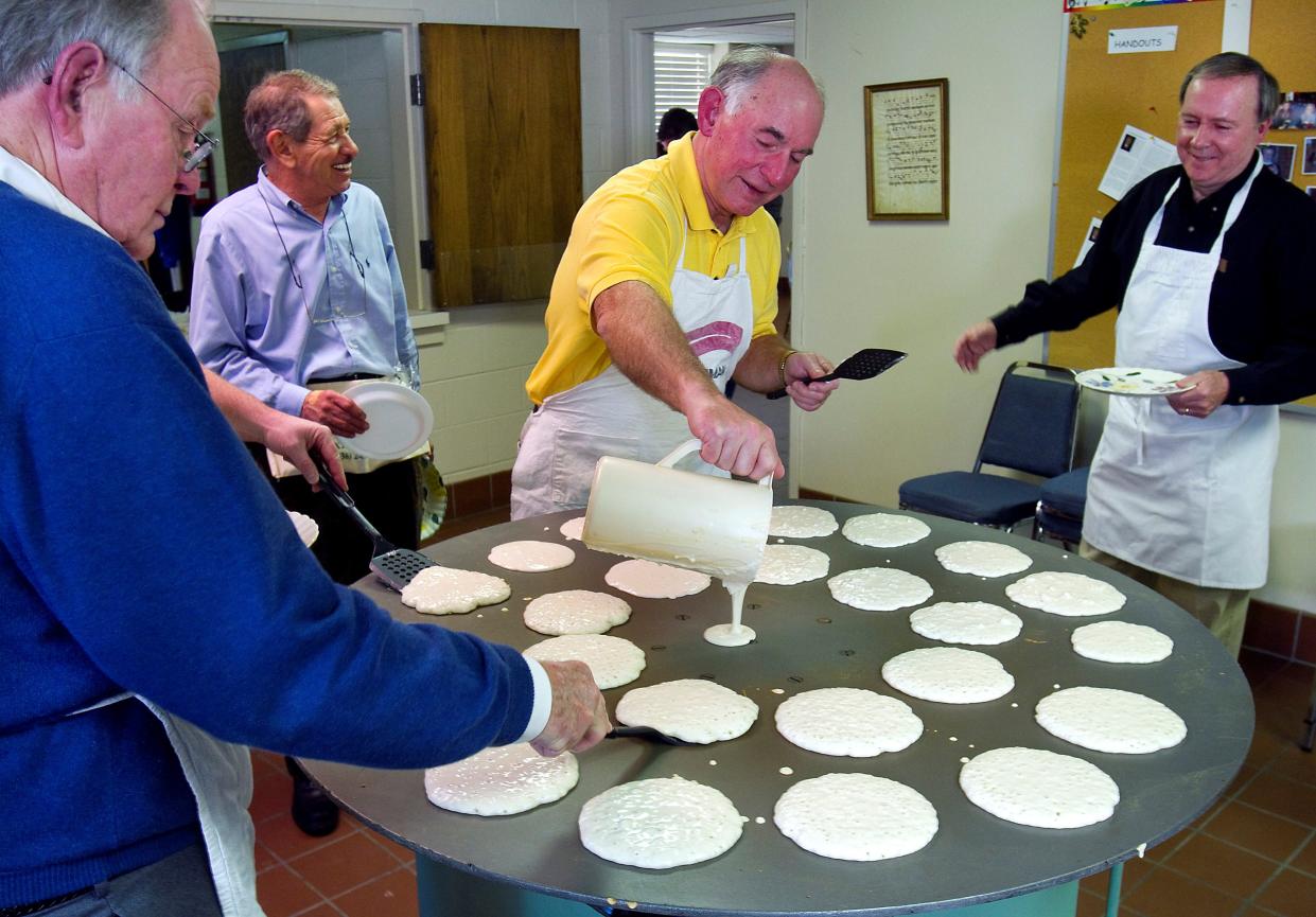 In this file photo, Grace Episcopal Church members gather around a large griddle to cook pancakes for their annual Shrove Tuesday Pancake Supper in Lexington. The event, set for Feb. 21 this year, is the first time the church men have been able to host the community event since the pandemic.