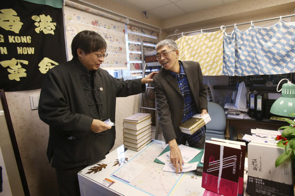 Lam Wing-kee, right, one of five shareholders and staff at the Causeway Bay Book shop in Hong Kong, works at his new book shop on the opening day in Taipei, Taiwan, Saturday, April 25, 2020. The part-owner of the Hong Kong bookstore specializing in texts critical of China’s leaders reopened his shop in Taiwan on Saturday after fleeing Hong Kong due to legal troubles, saying he was grateful for the opportunity to make China's Communist rulers “less than happy." (AP Photo/Chiang Ying-ying)