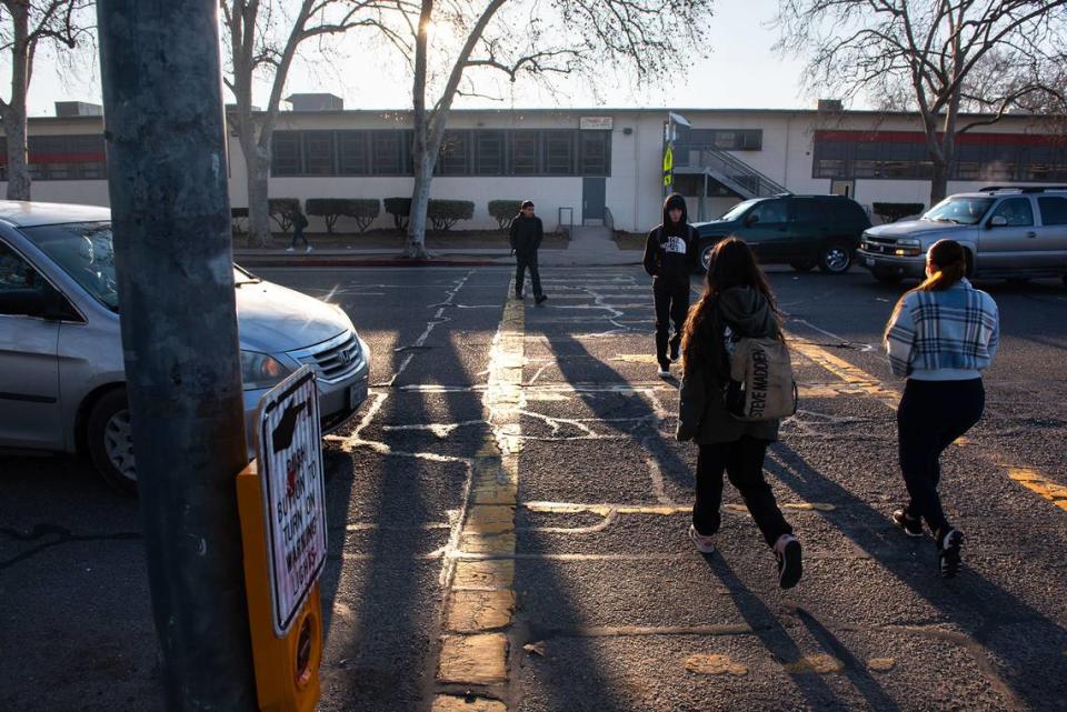 Modesto High School students cross Paradise Road in Modesto, Calif., Thursday, Jan. 26, 2023.