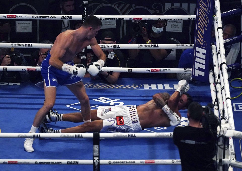 Britain's Callum Smith, left, knocks down Dominican Republic's Lenin Castillo during their Light-Heavyweight contest at the Tottenham Hotspur Stadium, in London, Saturday, Sept. 25, 2021. Castillo was taken to hospital after being carried out of the ring on a stretcher following a devastating knockout by British opponent Callum Smith. Event promoter Eddie Hearn says the 33-year-old Castillo was “responsive” after needing treatment by medical staff in the ring at Tottenham Hotspur Stadium in one of the fights on the undercard of the world heavyweight title bout between Anthony Joshua and Oleksandr Usyk. Castillo’s legs appeared to spasm after he hit the canvas and referee Bob Williams quickly called off the fight in the second round.(Nick Potts/PA via AP)