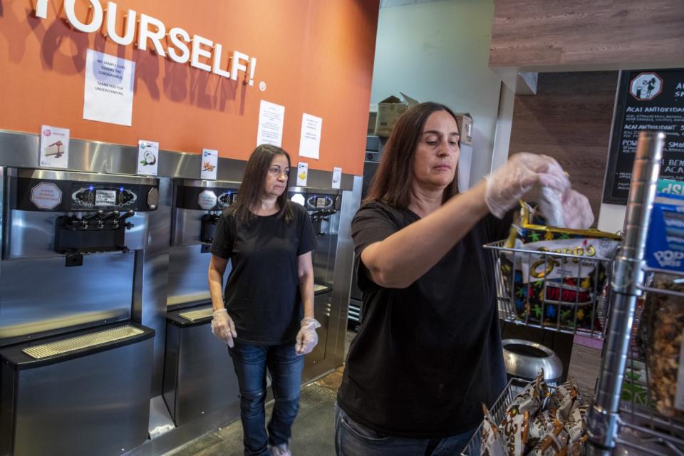 Shoshana Joseph, left, and her wife, Marta Knittel, in their shop, Yogurt Stop.