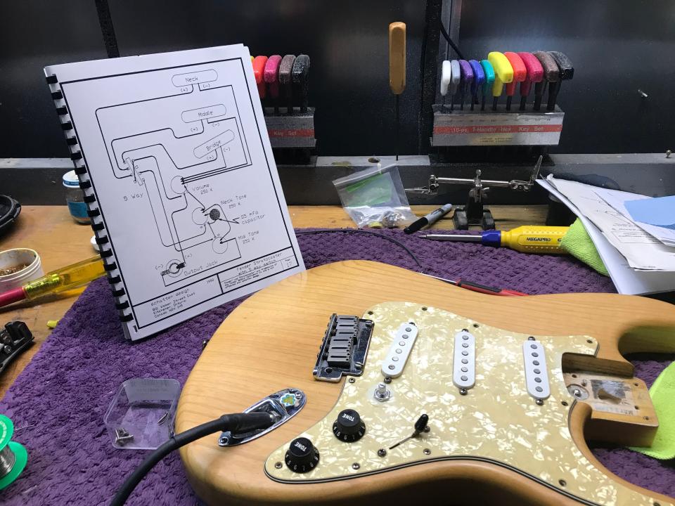 Schematics and tools on a work table at Jaros Custom Guitars.