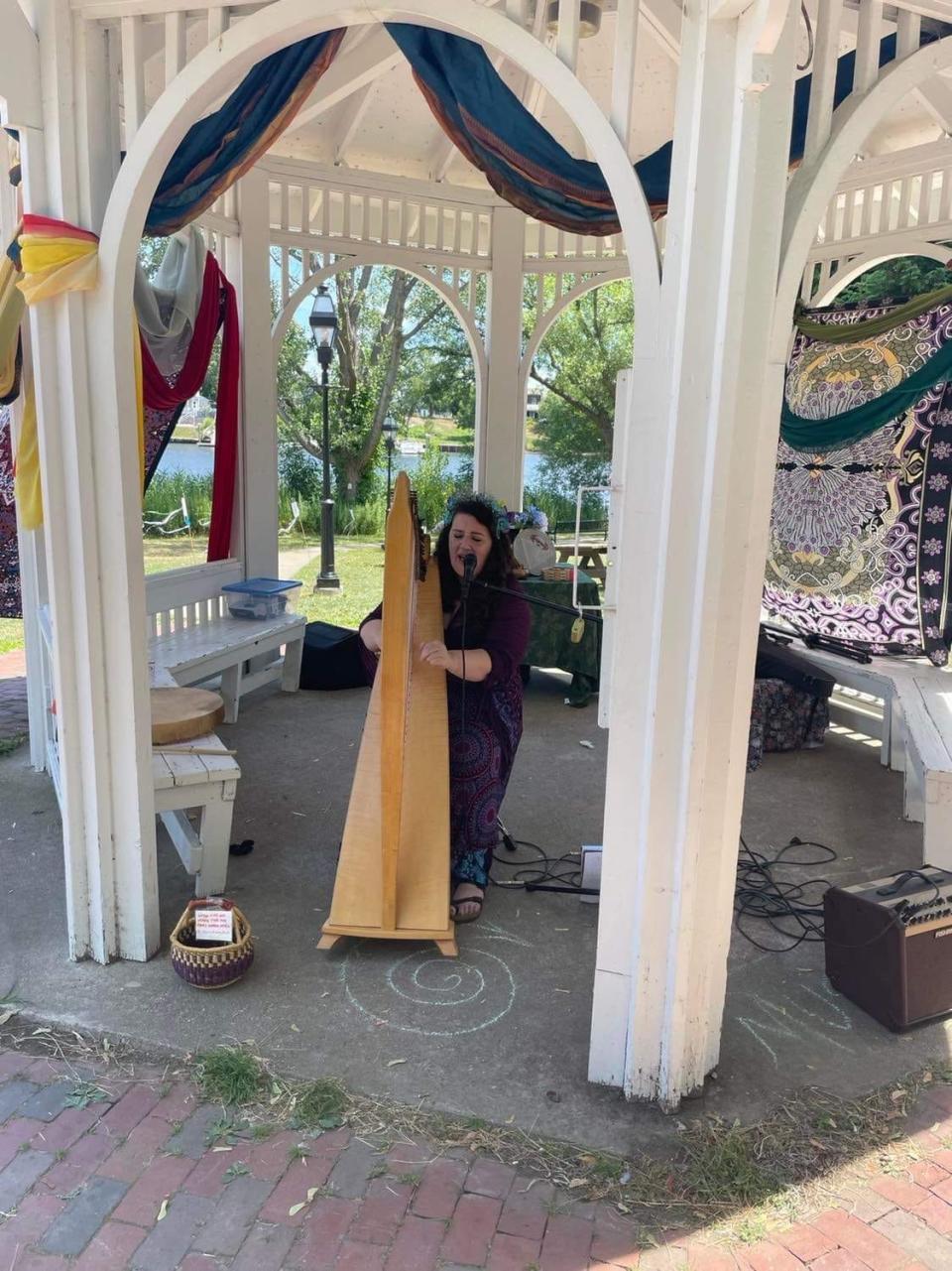 Jenna Greene entertains passersby during the first-ever Day of Witchery in Pawtuxet Park on Sunday.