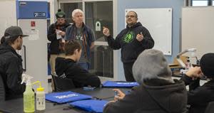 Professors Jim DeKloe and Michael Silva discuss programs with students.