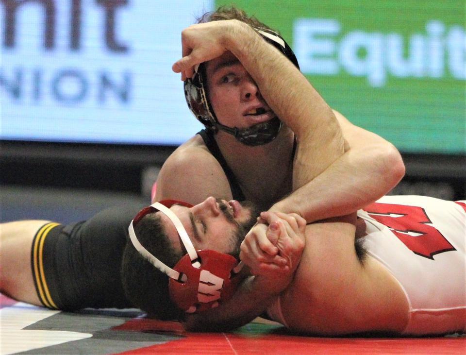 Iowa's Spencer Lee nears a pin against Wisconsin's Eric Barnett at 125 pounds during the teams' dual at the UW Field House on Jan. 22, 2023.