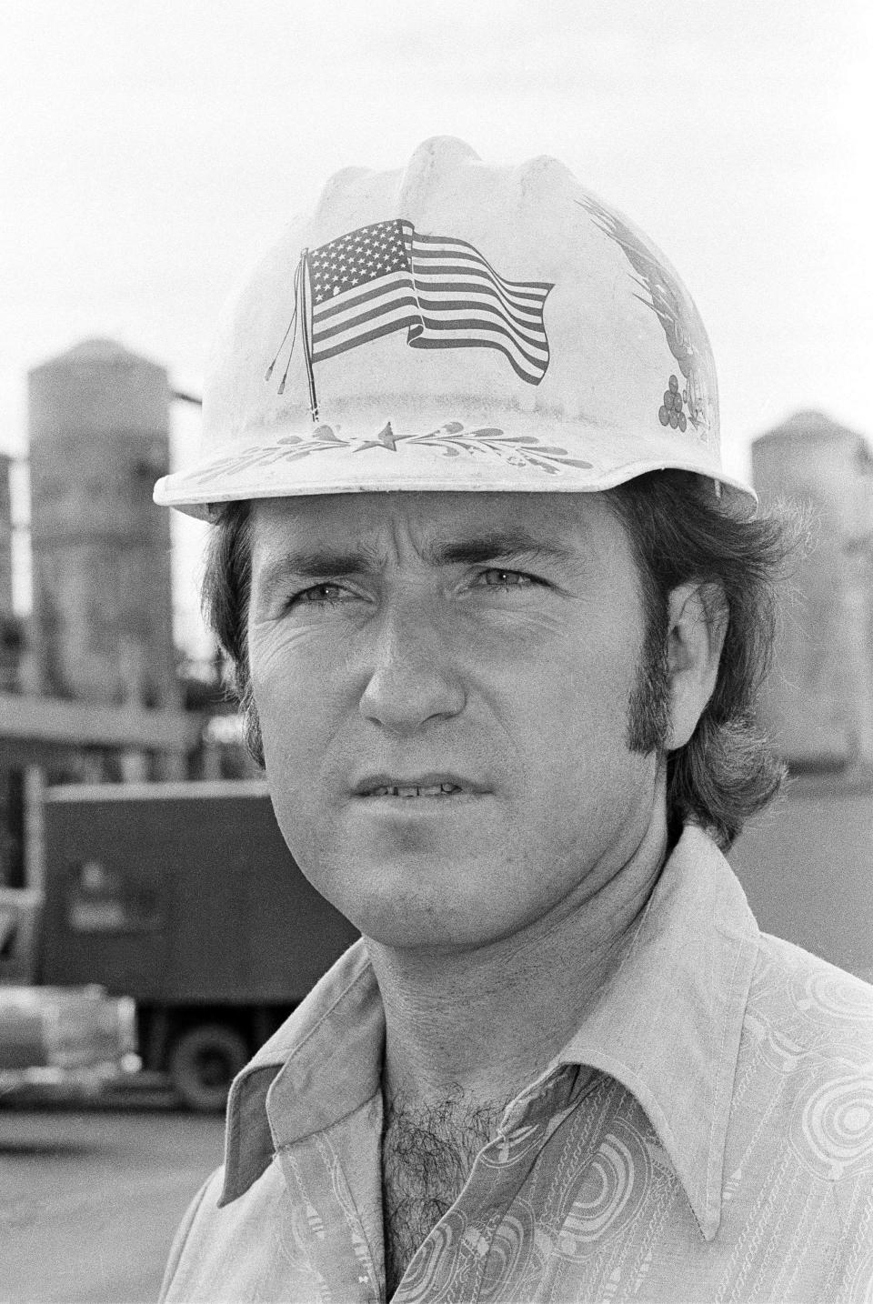 Brian Weber wears a hard hat with an American flag outside the Kaiser Aluminum and Chemical Co. plant in Gramercy, Louisiana on July 19, 1978.