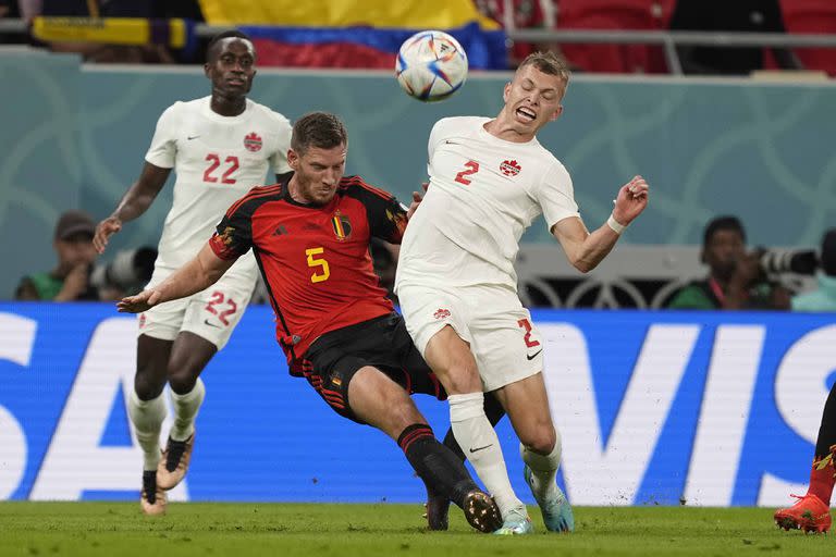 Belgium's Jan Vertonghen, left, challenges for the ball with Canada's Alistair Johnston during the World Cup group F soccer match between Belgium and Canada, at the Ahmad Bin Ali Stadium in Doha, Qatar, Wednesday, Nov. 23, 2022. (AP Photo/Martin Meissner)