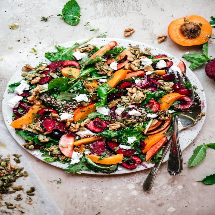 Quinoa salad with lettuce, cherries, peaches, and more.