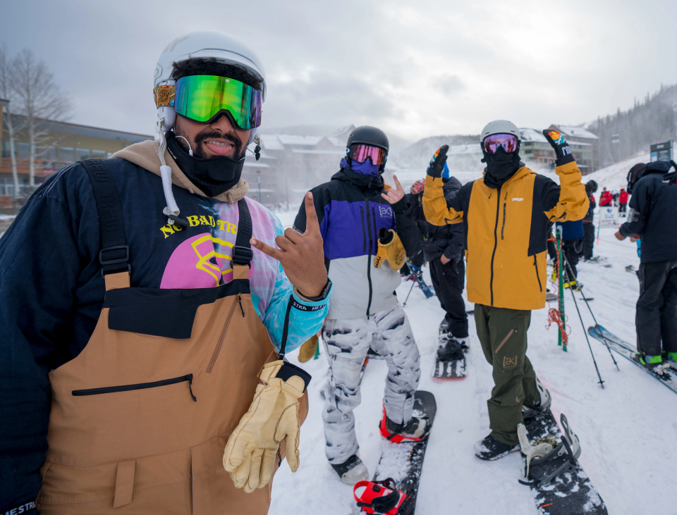 Snowboarders celebrate opening day before boarding a chairlift Nov. 17, 2021, at Winter Park (Colo.) Resort.