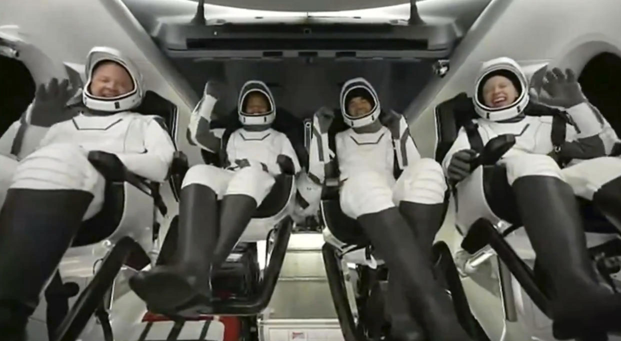 The four passengers react as the capsule parachutes into the Atlantic Ocean (SpaceX via AP)