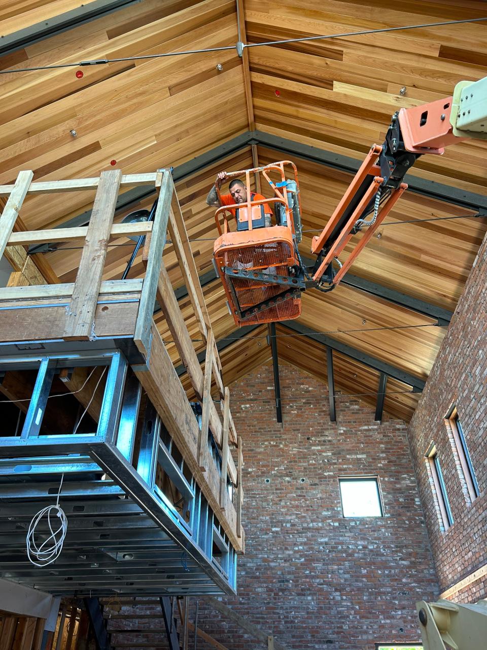 Joe Dominguez of E-Z Painting works around the cedar ceiling inside Pipeline Redding, a gastropub that is scheduled to open in fall 2024.