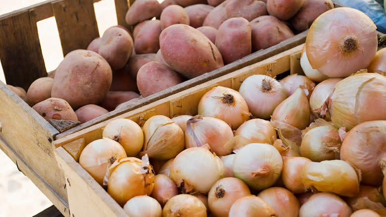 potatoes and onions in crates