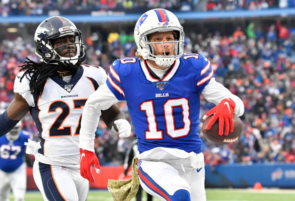 Buffalo Bills wide receiver Cole Beasley (10) reacts to scoring a touchdown in front ofDenver Broncos cornerback Davontae Harris (27) in the third quarter at New Era Field.